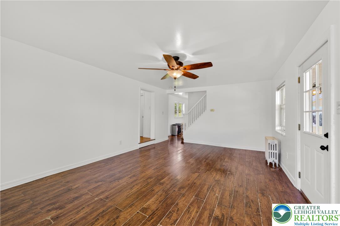1411 Lieb Road Easton, PA 18040 - Photo 18 of 46 Hardwood floors and a ceiling fan create a comfortable atmosphere in this inviting living space.
