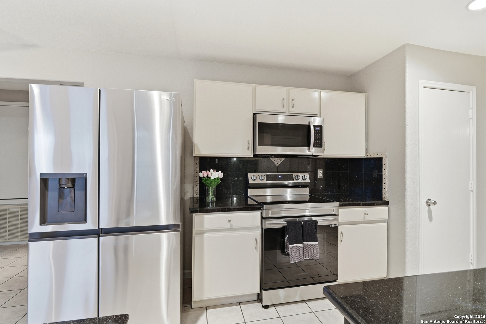 814 Inks Farm San Antonio, TX 78228 - Photo 14 of 32 a kitchen with stainless steel appliances a refrigerator stove and microwave