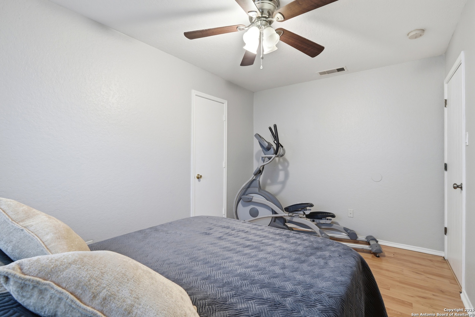 814 Inks Farm San Antonio, TX 78228 - Photo 23 of 32 a bedroom with a bed and a chandelier