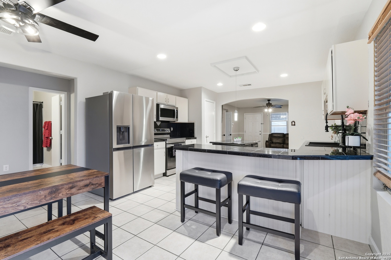 814 Inks Farm San Antonio, TX 78228 - Photo 3 of 32 a kitchen with refrigerator and chairs