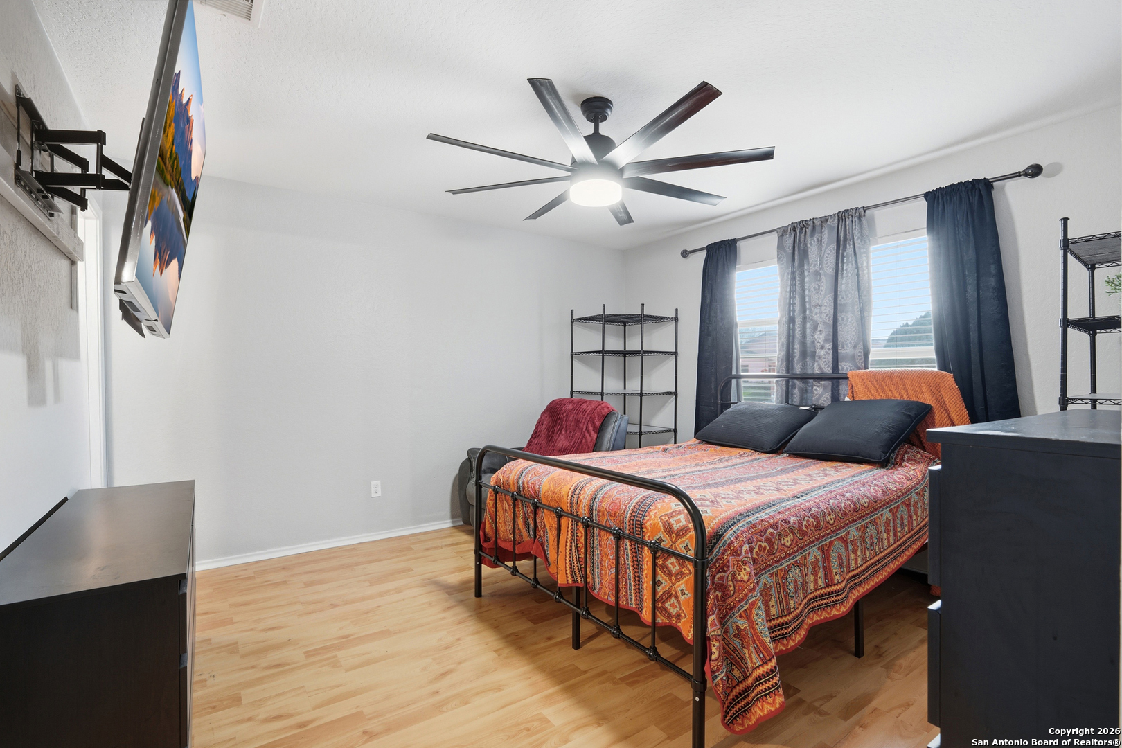 814 Inks Farm San Antonio, TX 78228 - Photo 4 of 32 a bedroom with a bed and a chandelier