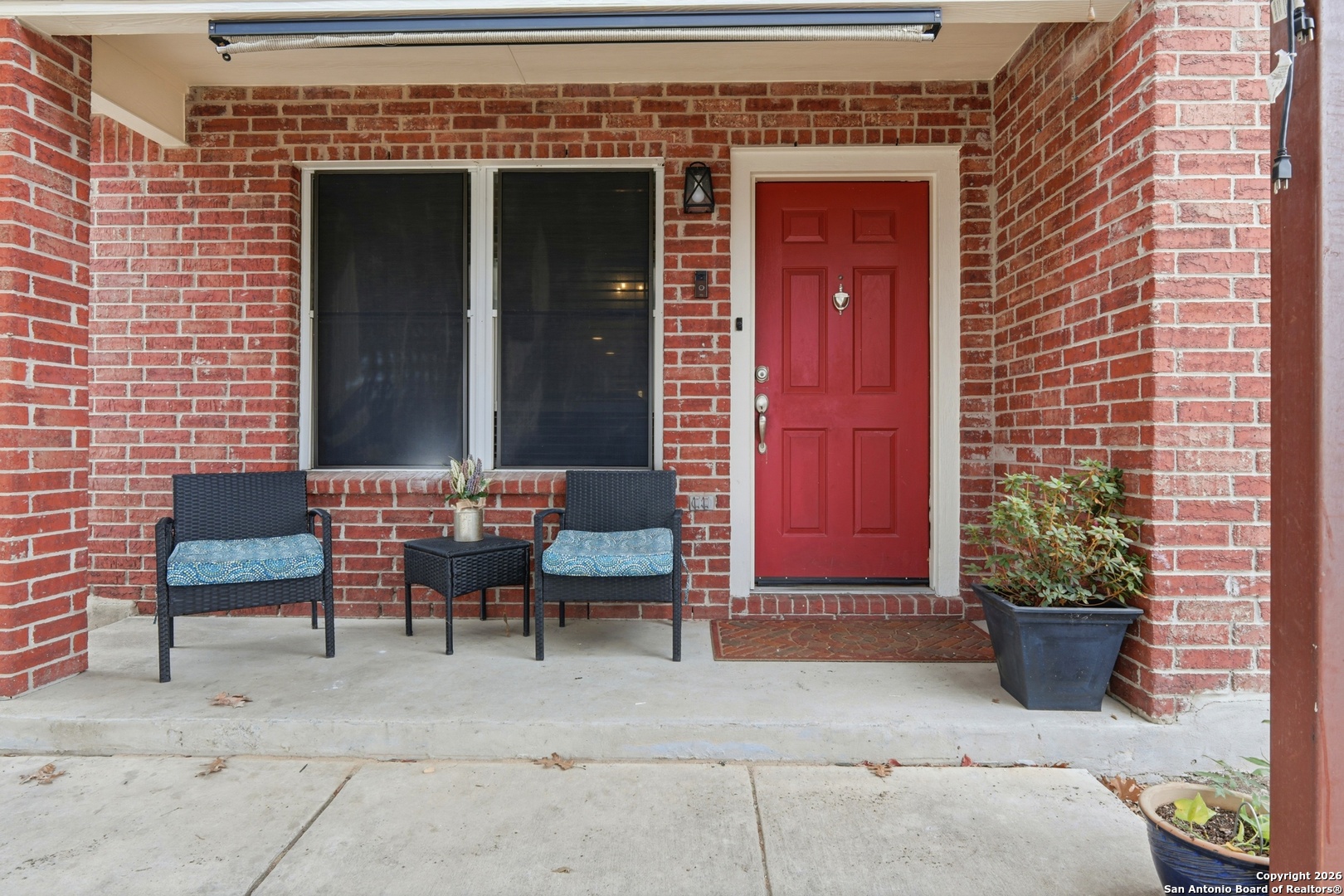 814 Inks Farm San Antonio, TX 78228 - Photo 9 of 32 a view of a brick house with chairs and potted plants