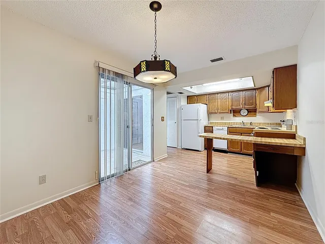 a view of kitchen with granite countertop microwave and refrigerator