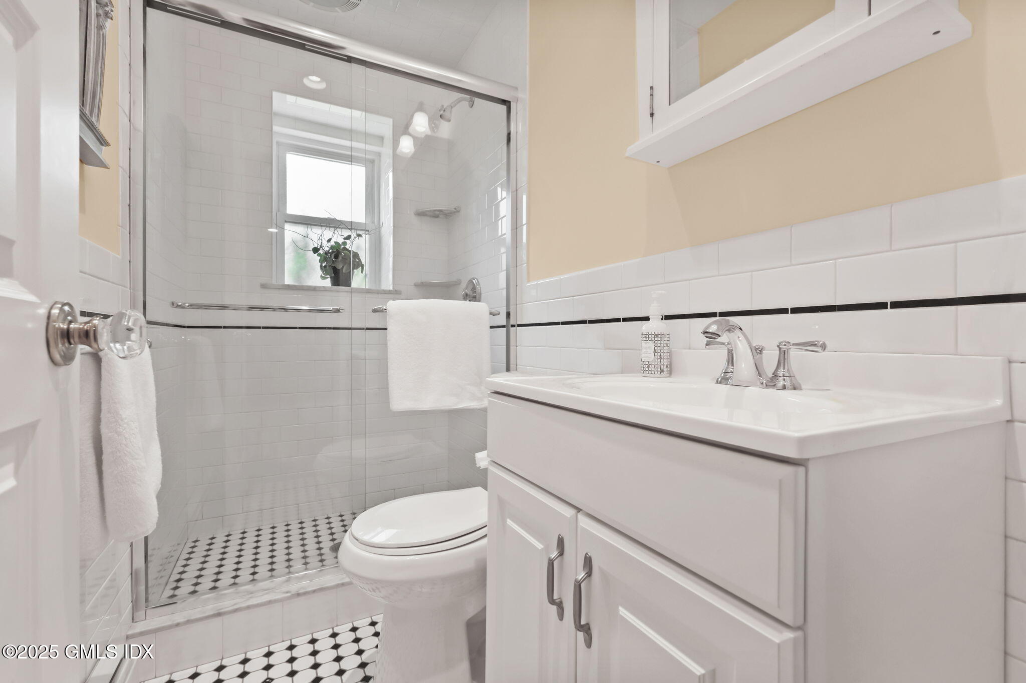 20 Church St W Greenwich, CT 06830 - Photo 11 of 31 a bathroom with a sink a toilet and a mirror