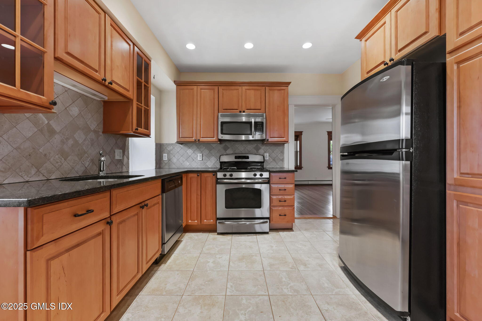 20 Church St W Greenwich, CT 06830 - Photo 16 of 31 a kitchen with granite countertop a stove top oven and cabinets