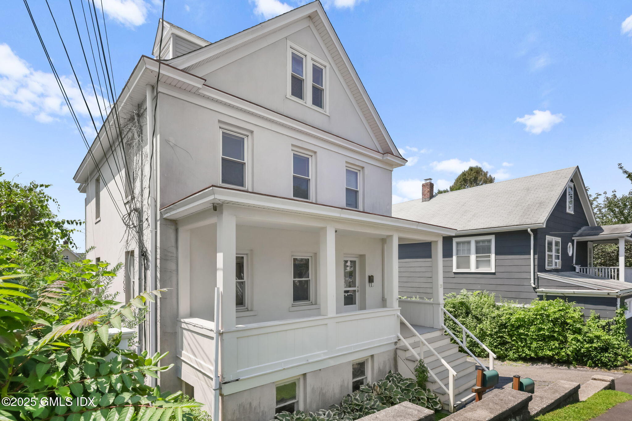 20 Church St W Greenwich, CT 06830 - Photo 2 of 31 a view of a white house with many windows