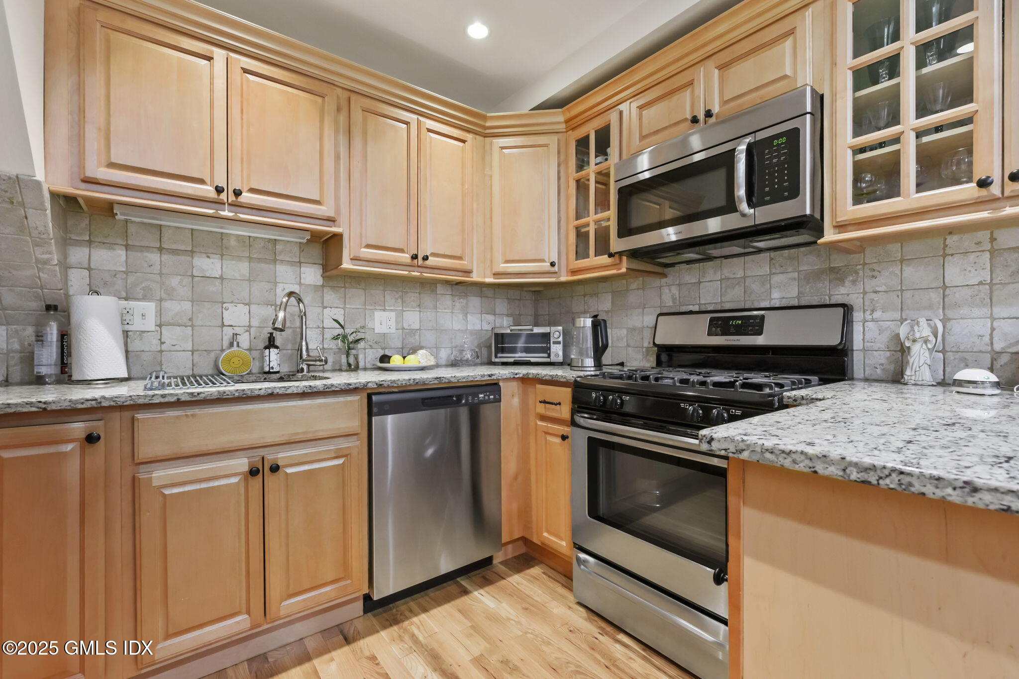 20 Church St W Greenwich, CT 06830 - Photo 8 of 31 a kitchen with stainless steel appliances granite countertop a stove microwave and cabinets
