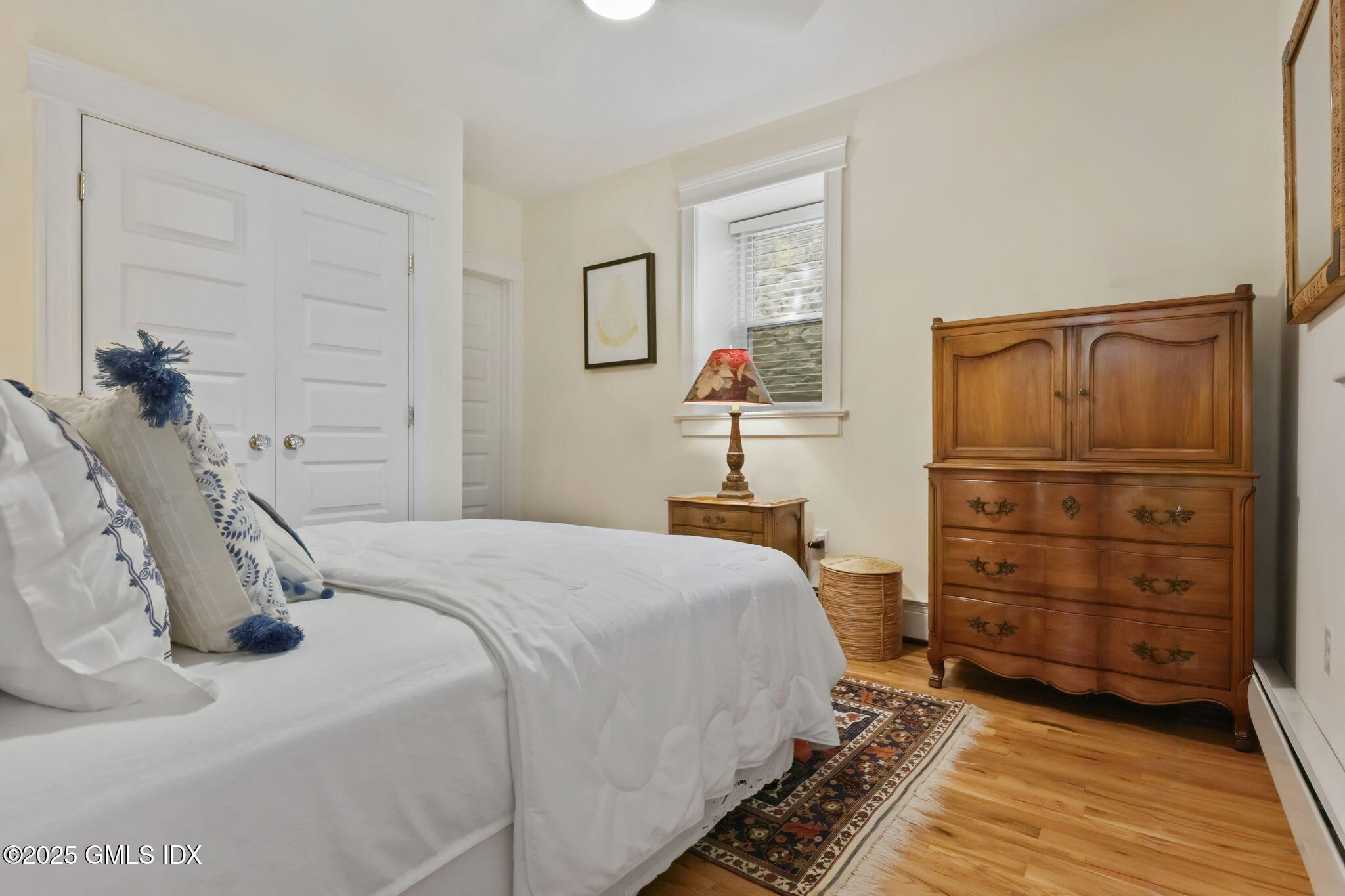 20 Church St W Greenwich, CT 06830 - Photo 9 of 31 a bedroom with a bed and wooden floor