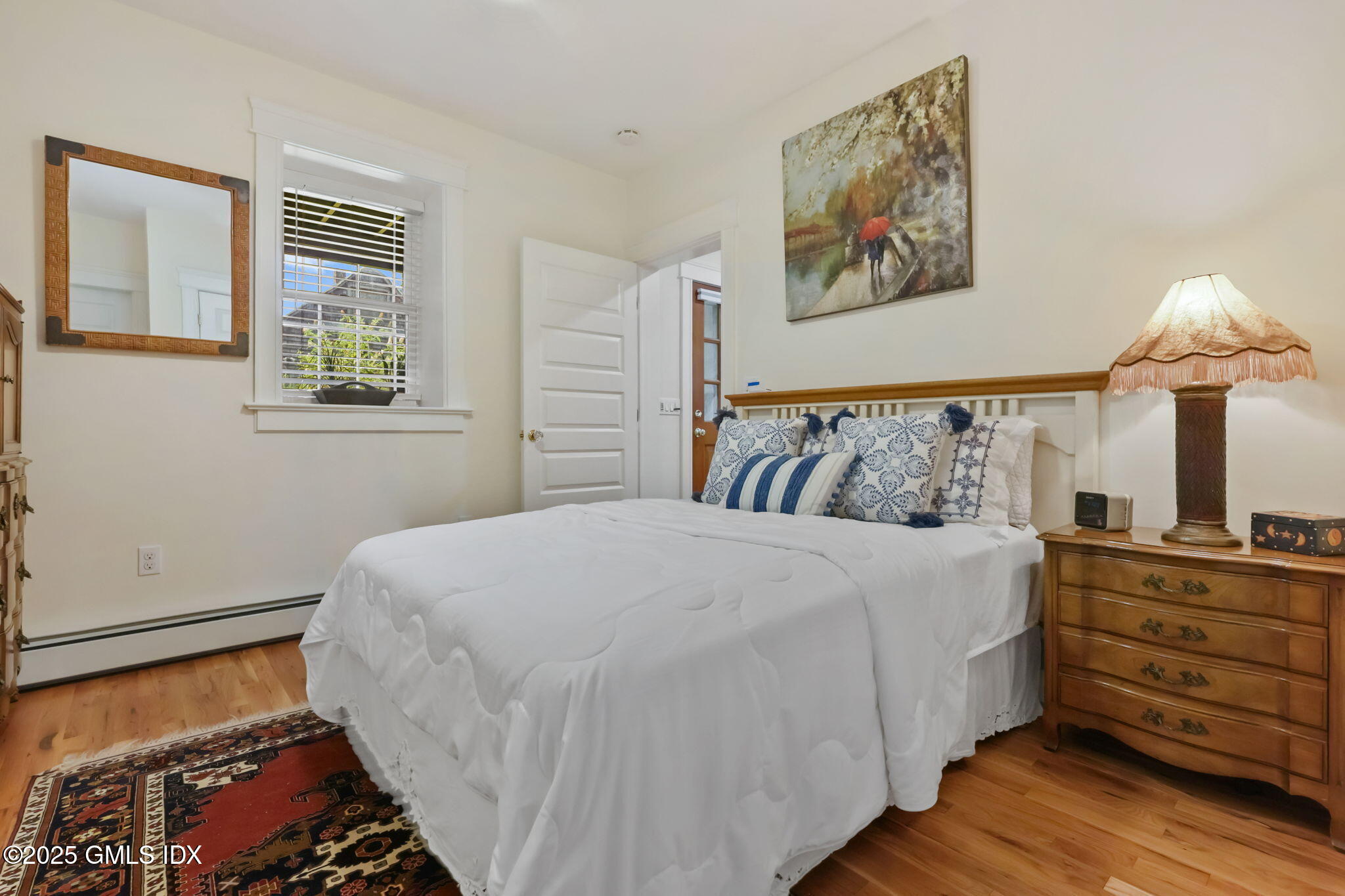 20 Church St W Greenwich, CT 06830 - Photo 10 of 31 a bedroom with a bed and a painting on the wall