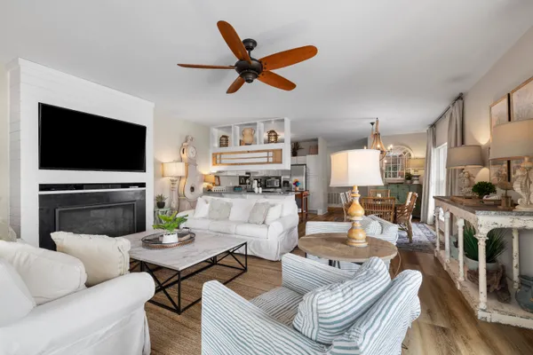 a living room with furniture a fireplace and a flat screen tv