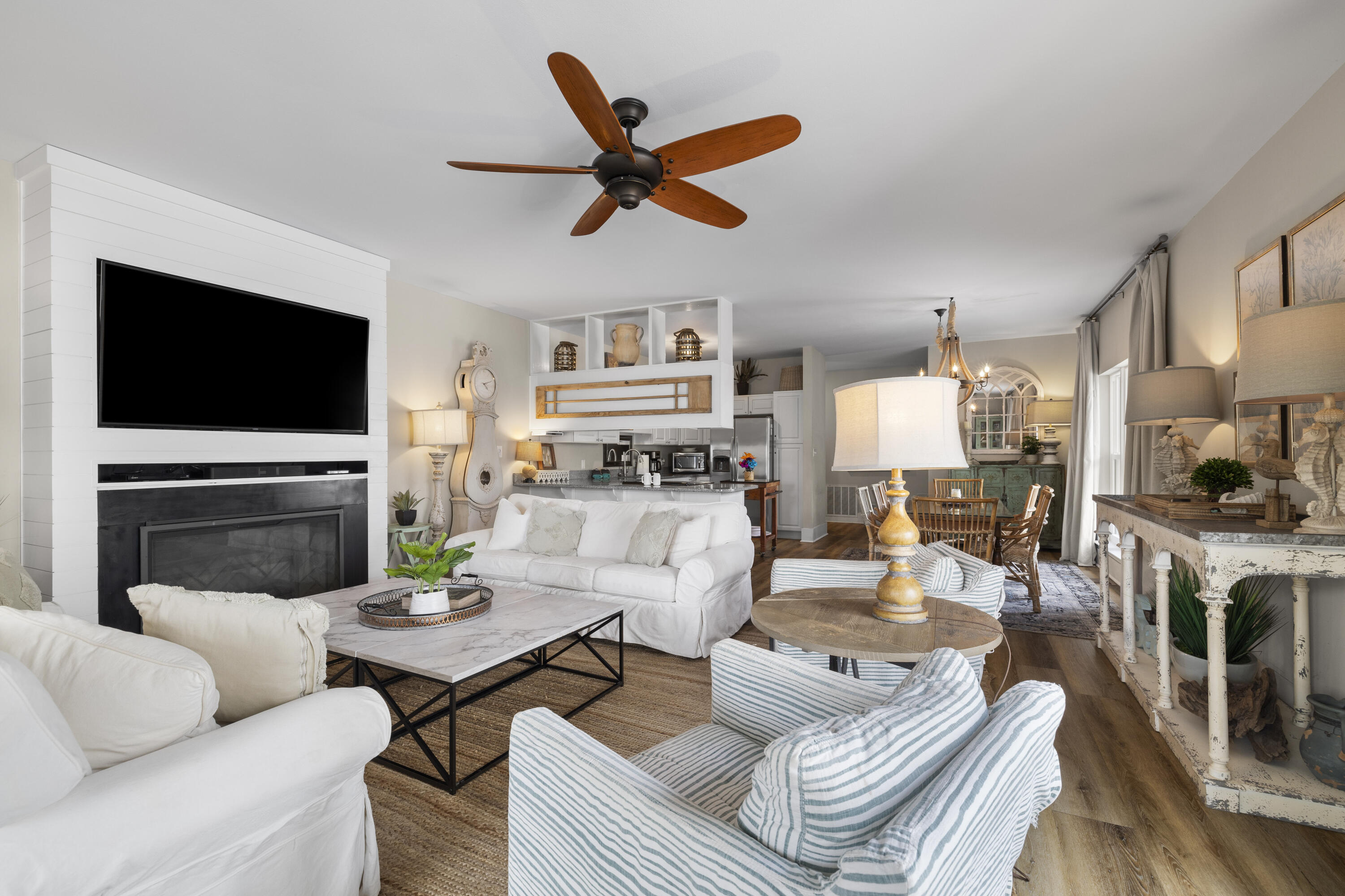 a living room with furniture a fireplace and a flat screen tv