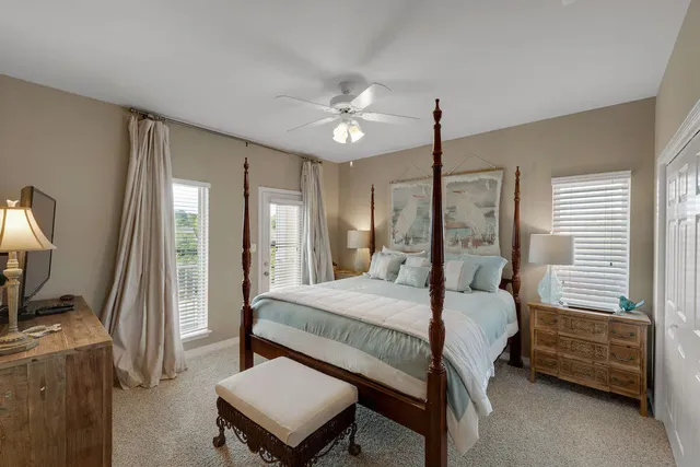a bedroom with a bed desk and a flat screen tv