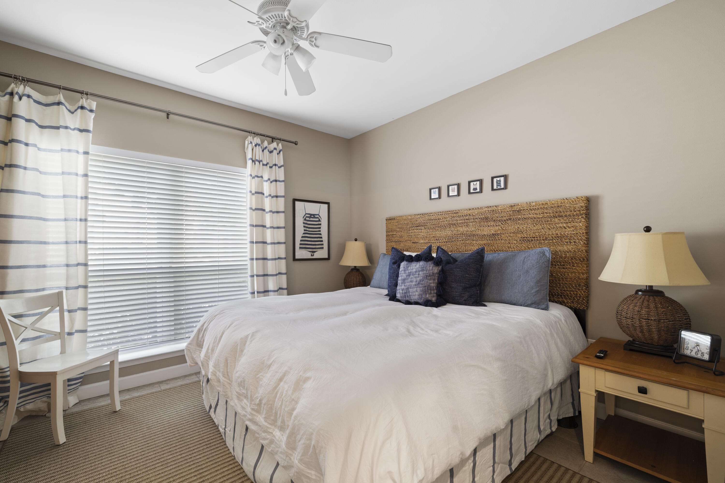 4192 East County Highway 30A, Unit A Santa Rosa Beach, FL 32459 - Photo 19 of 30 a bedroom with a bed and a chandelier