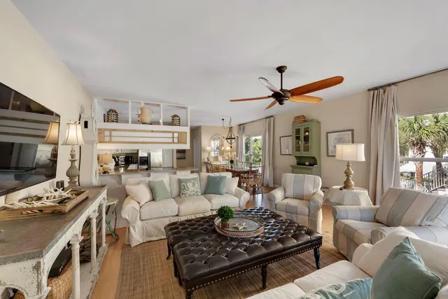 a living room with furniture a rug and a window