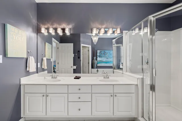 a bathroom with double sink and a mirror