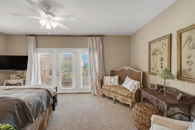 a spacious bedroom with a bed a couch and a flat screen tv