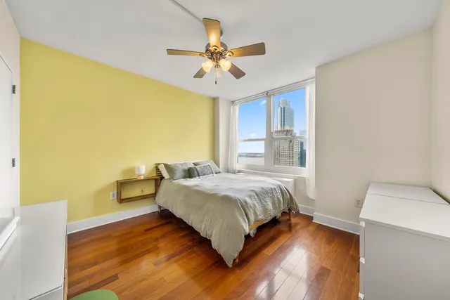 a bedroom with a bed and a chandelier