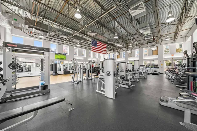 a view of a room with lots of wooden furniture and chandelier