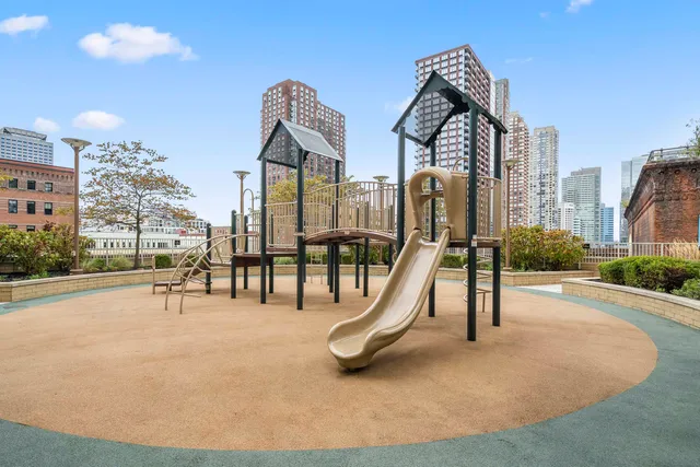 a view of a park with swings and slides