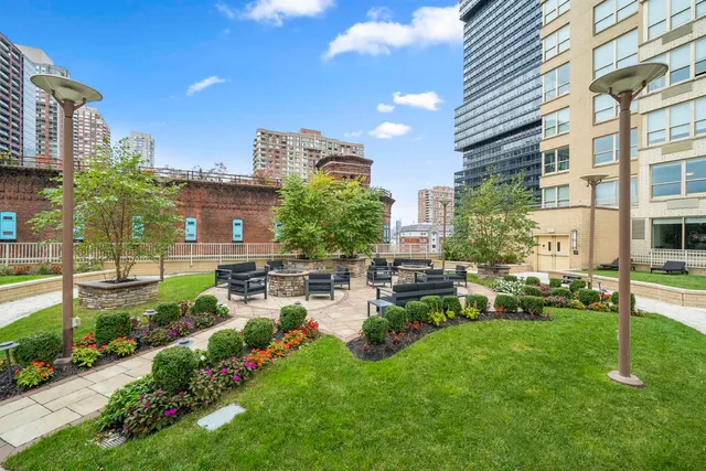 a view of a house with backyard sitting area and garden