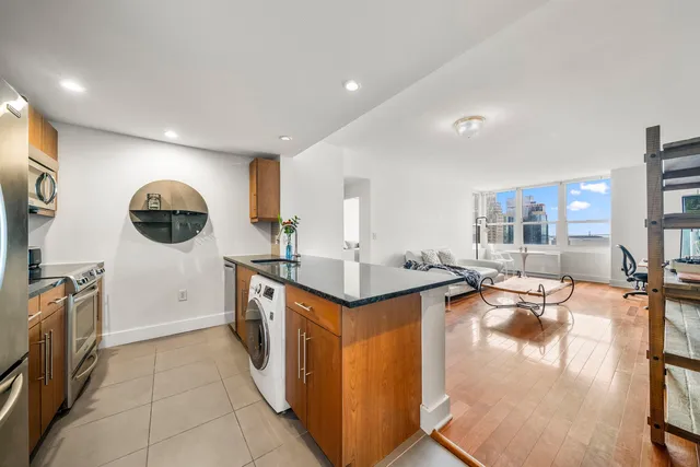 a kitchen with stainless steel appliances granite countertop a sink and stove