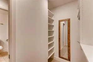 a view of a hallway with wooden floor and entryway