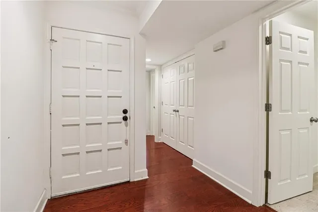 a view of a hallway with wooden floor