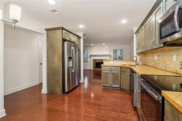 a kitchen with a refrigerator sink and cabinets
