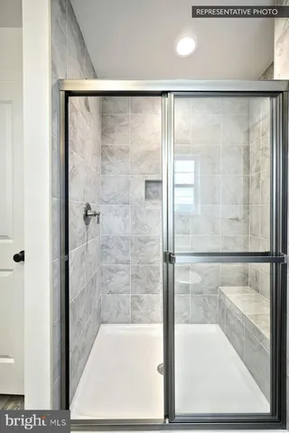 a bathroom with a glass shower door