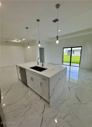 a kitchen with white cabinets and refrigerator