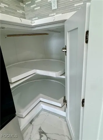 a kitchen with granite countertop a stove and a microwave