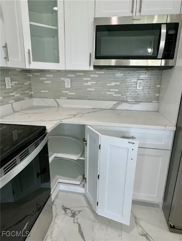 a stove top oven sitting inside of a kitchen