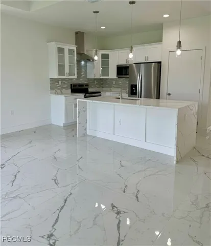 a kitchen with granite countertop a sink and stainless steel appliances