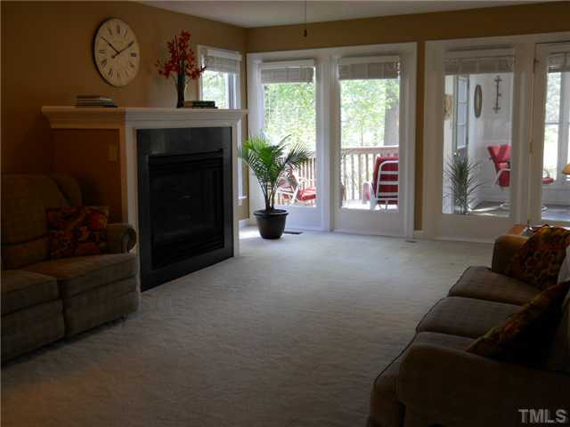 2957 Tillinghast Trail Raleigh, NC 27613 - Photo 6 of 25 Large living room to spend time with family or watching TV. Wall of windows overlook golf course.