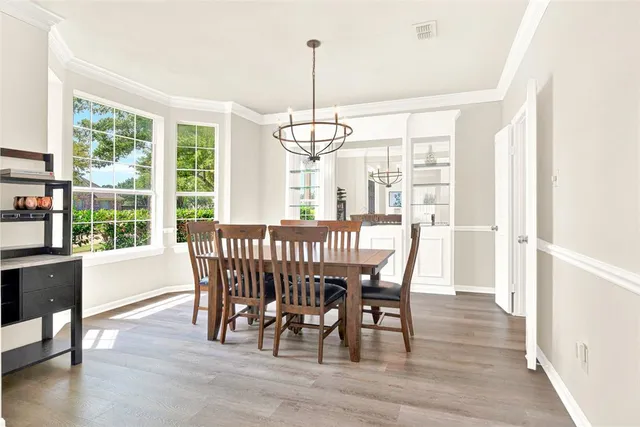 a dining room with furniture window wooden floor