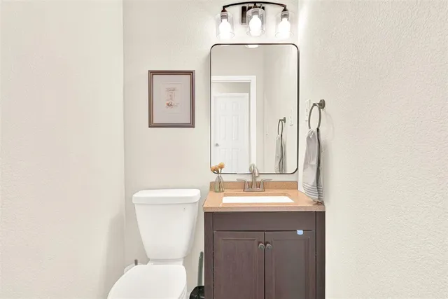 a bathroom with a toilet a sink and mirror