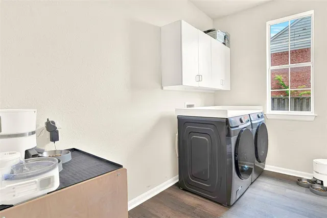 a utility room with sink dryer and washer