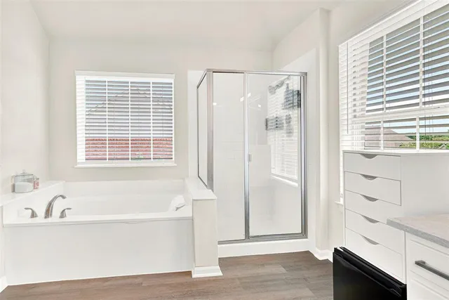 a bathroom with bathtub and window