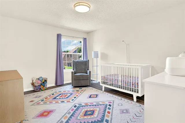 a view of a bedroom with baby bed