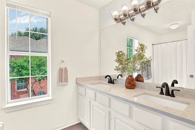 a bathroom with a sink and a window