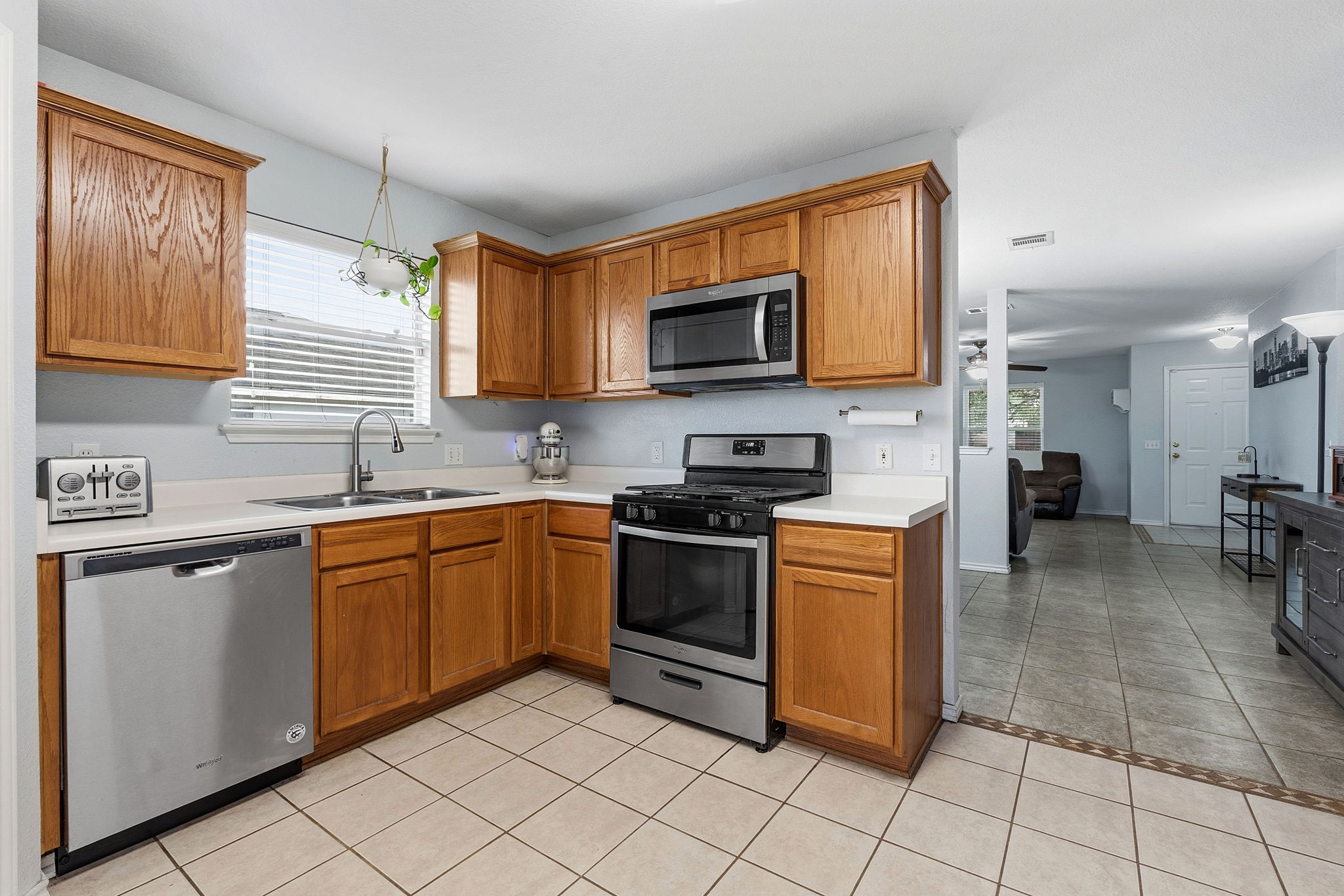626 Atlantis Kyle, TX 78640 - Photo 5 of 23 a kitchen with stainless steel appliances granite countertop a stove top oven a sink a counter top space and cabinets