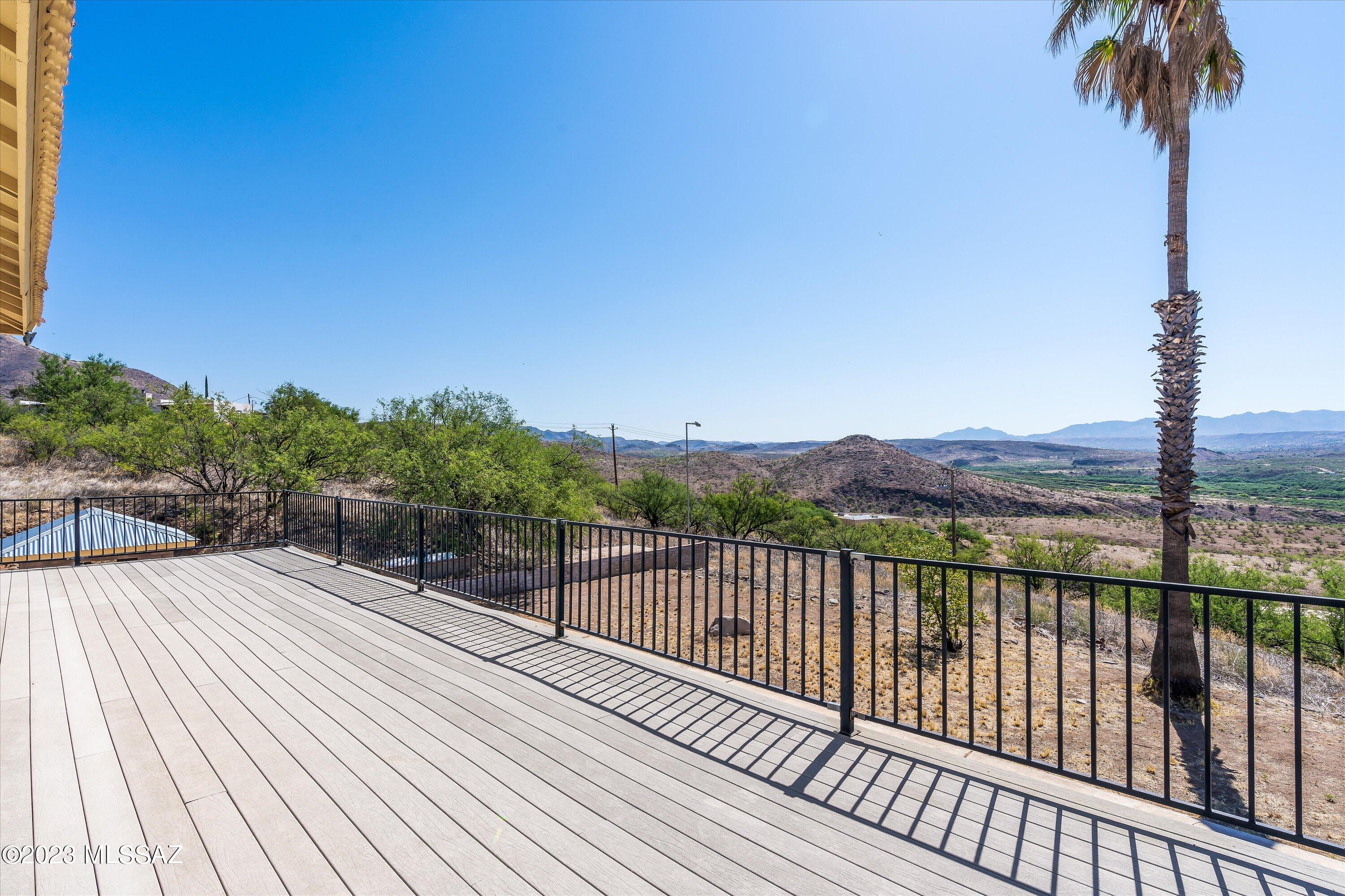 1226 Avenida Gloriosa Rio Rico, AZ 85648 - Photo 31 of 46 a view of balcony with wooden floor and fence