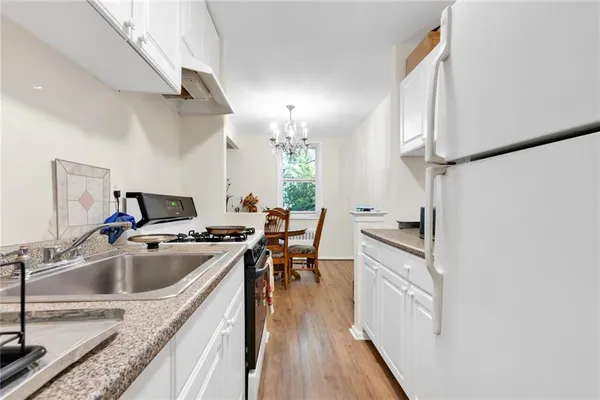 a kitchen with a sink a stove and cabinets
