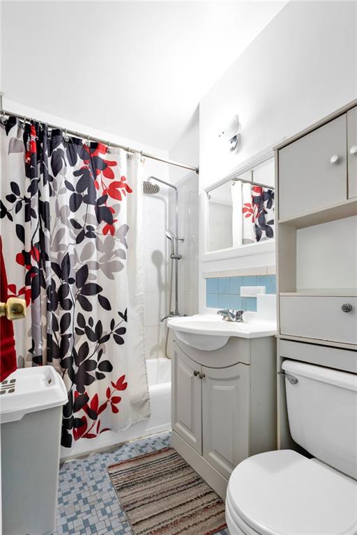 2155 82nd Street, Unit 3J Brooklyn, NY 11214 - Photo 13 of 15 a bathroom with a sink toilet and shower