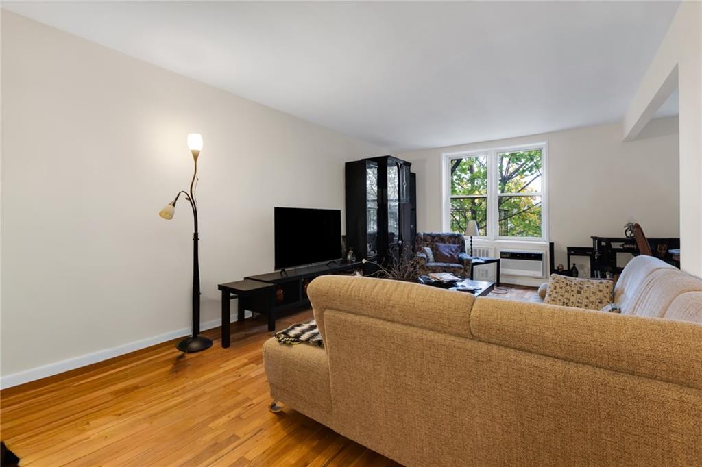 2155 82nd Street, Unit 3J Brooklyn, NY 11214 - Photo 5 of 15 a living room with furniture and a flat screen tv