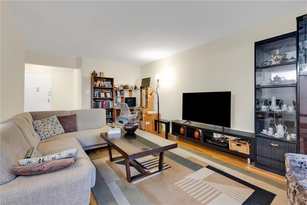 2155 82nd Street, Unit 3J Brooklyn, NY 11214 - Photo 6 of 15 a living room with furniture and a flat screen tv