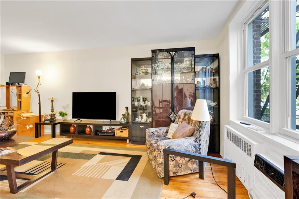 2155 82nd Street, Unit 3J Brooklyn, NY 11214 - Photo 7 of 15 a living room with furniture and a flat screen tv