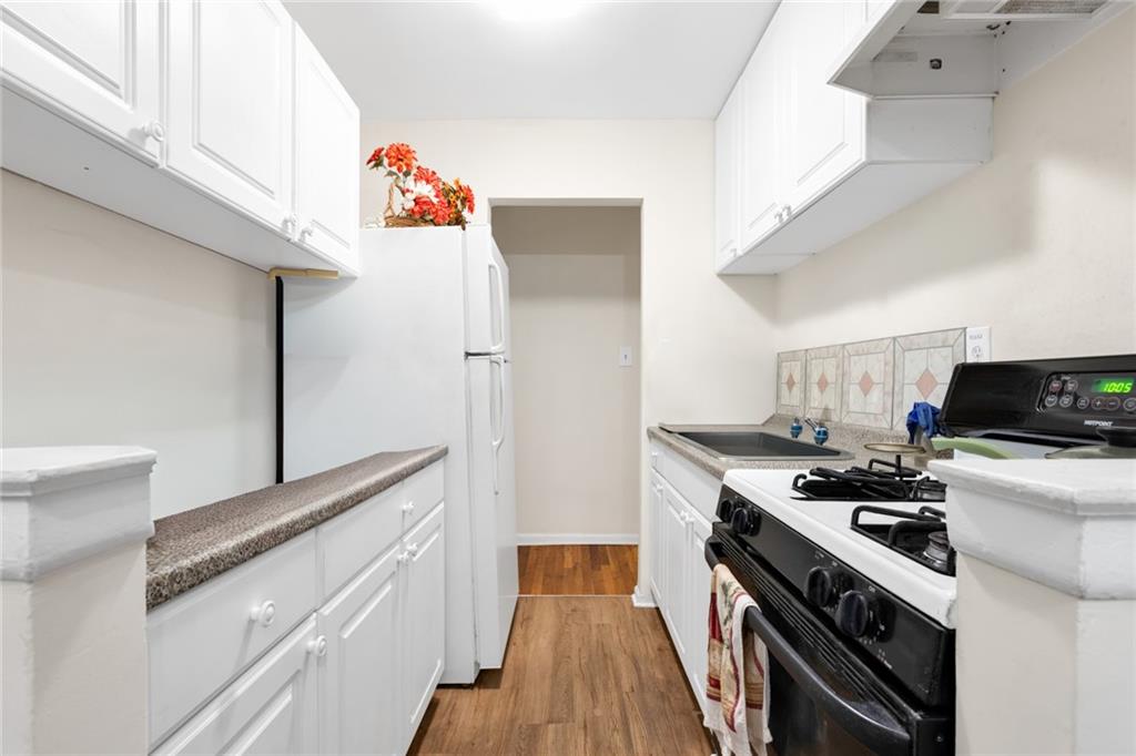 2155 82nd Street, Unit 3J Brooklyn, NY 11214 - Photo 8 of 15 a kitchen with a stove and a refrigerator