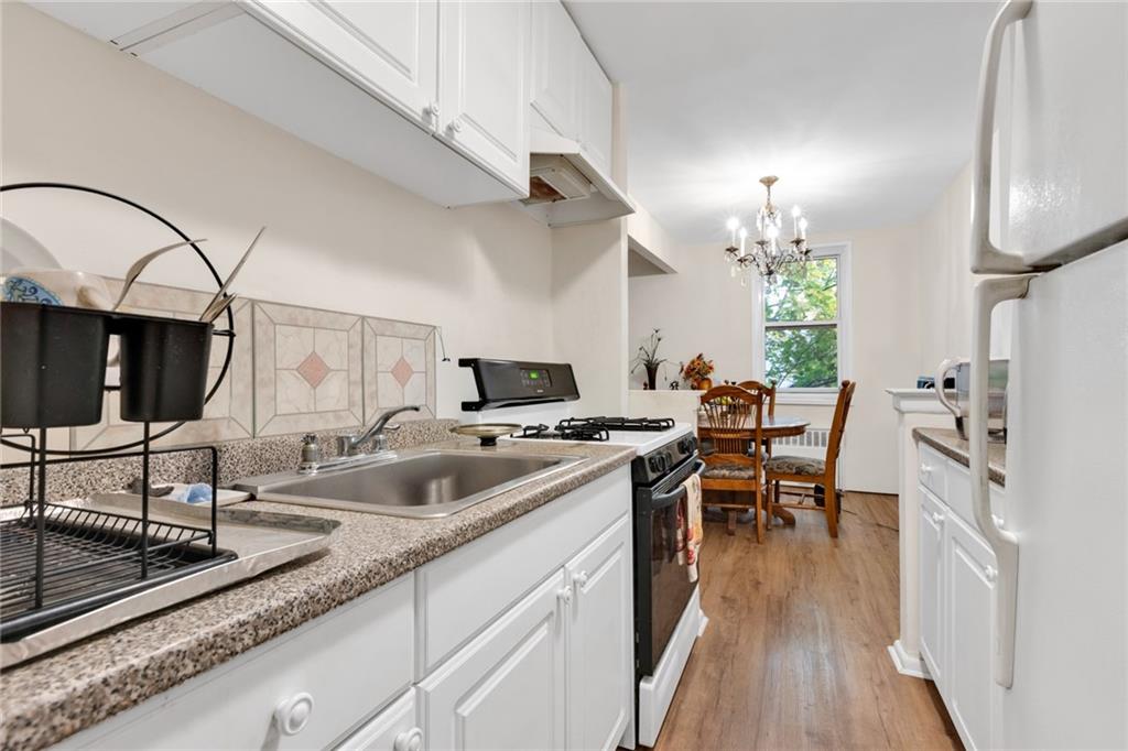 2155 82nd Street, Unit 3J Brooklyn, NY 11214 - Photo 10 of 15 a kitchen with sink cabinets and outdoor living space