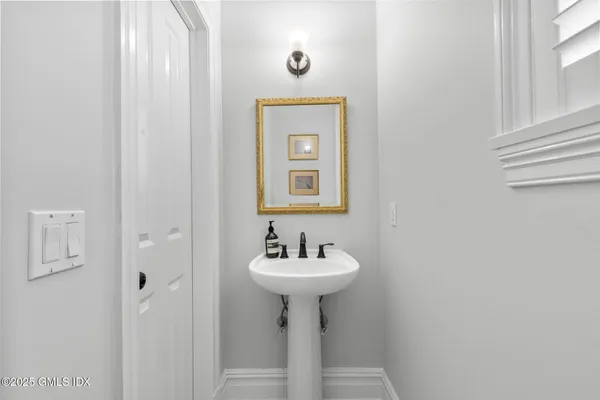 a bathroom with a sink a mirror and a window